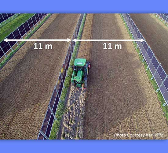 Farm vehicle passing between solar panels; courtesy Karl Wild