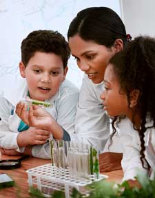 A teacher and young students in a laborator